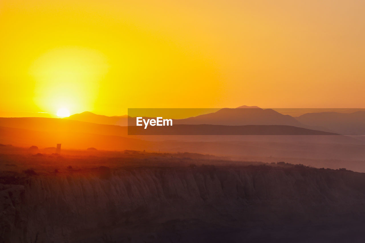 Scenic view of landscape against sky during sunset