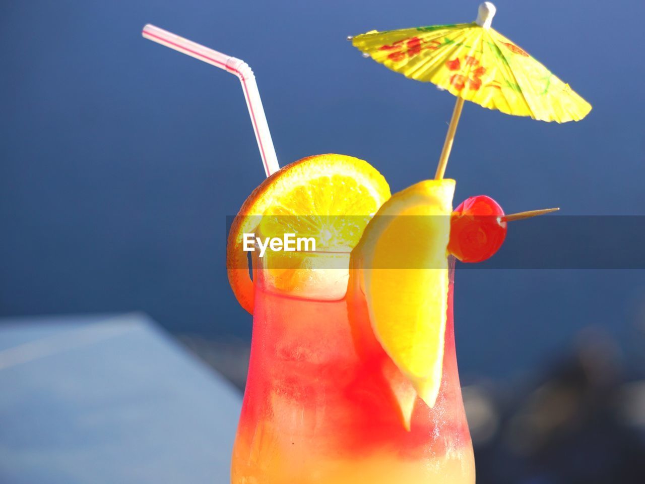 Close-up of drink in glass against blue sky