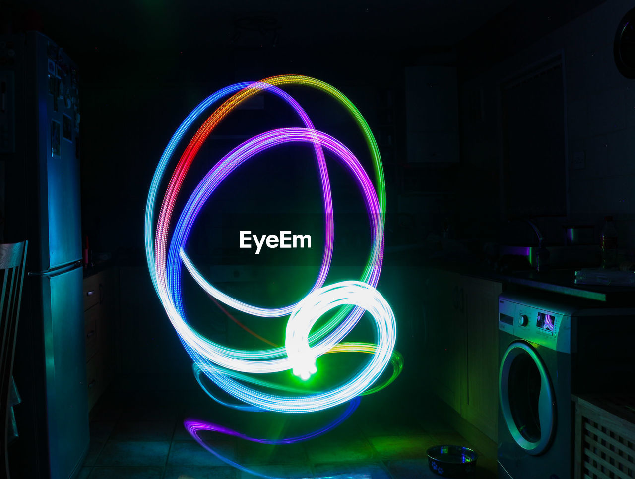 Colorful light trails in kitchen at home