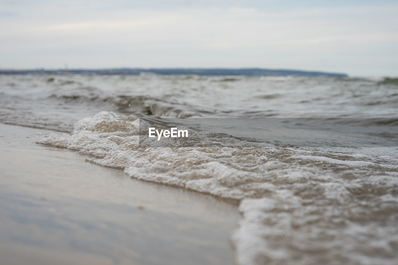 Surface level of sea shore against sky