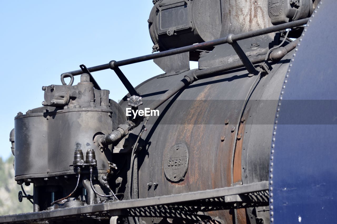 LOW ANGLE VIEW OF TRAIN ON RAILROAD TRACK AGAINST SKY