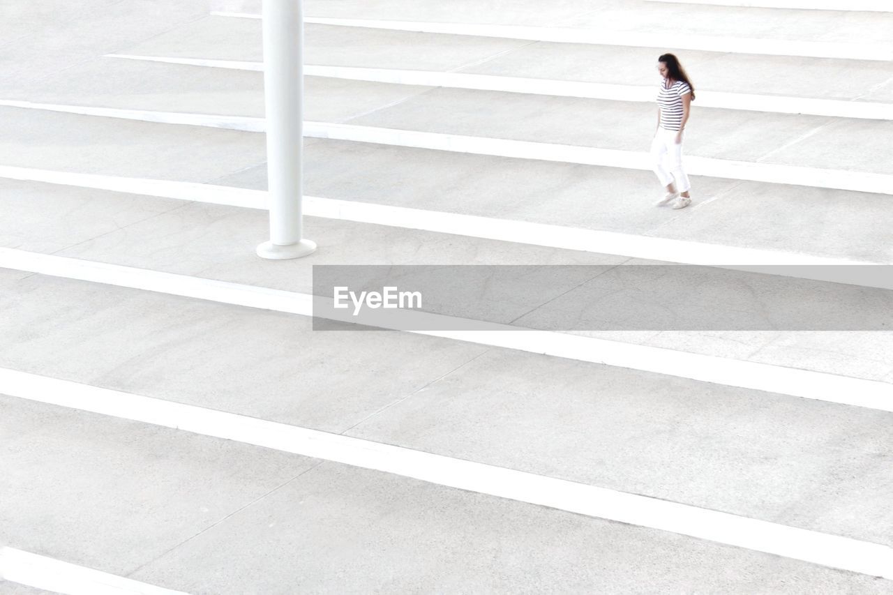 High angle view of woman walking on staircase