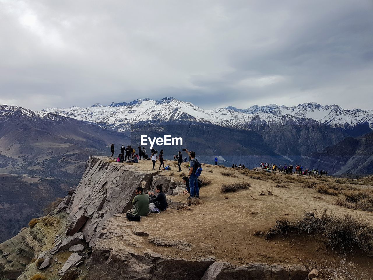 Hikers enjoying on mountain against sky