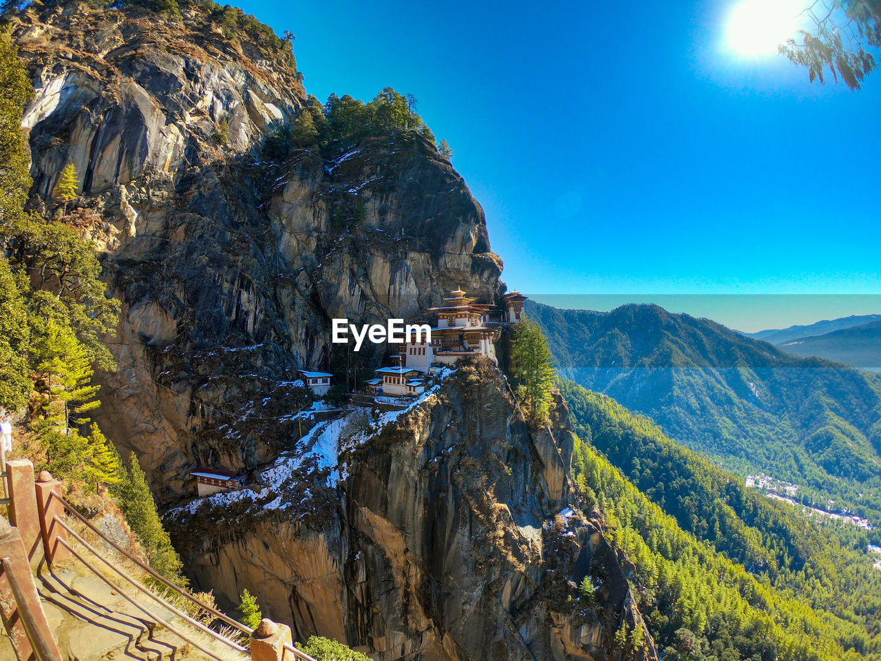 Scenic view of mountains against blue sky