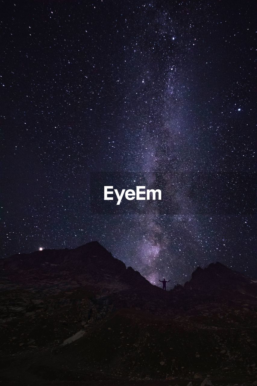Scenic view of mountain against star field