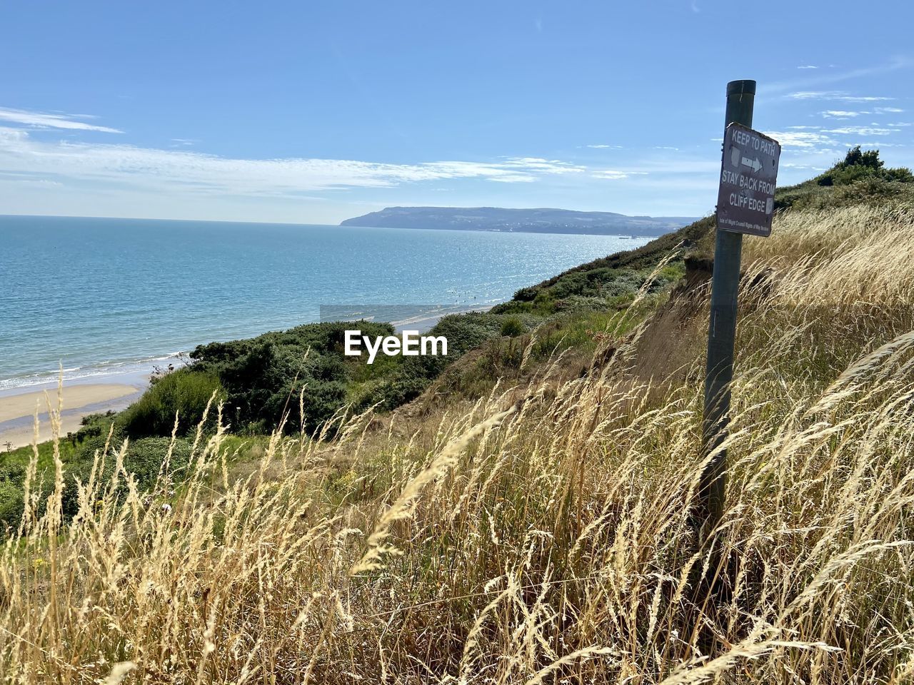 sea, land, sky, coast, water, beach, scenics - nature, nature, plant, beauty in nature, grass, tranquility, landscape, tranquil scene, shore, environment, no people, horizon, cliff, horizon over water, day, coastline, cloud, outdoors, non-urban scene, travel destinations, mountain, ocean, terrain, blue, travel, idyllic, architecture, holiday, tourism, rural scene, sunlight, vacation, trip, sand