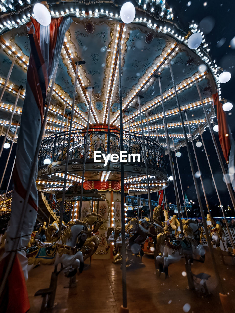 LOW ANGLE VIEW OF ILLUMINATED FERRIS WHEEL