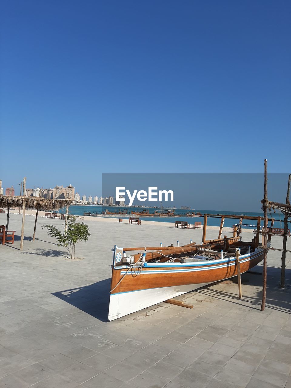 BOATS MOORED IN SEA AGAINST CLEAR SKY