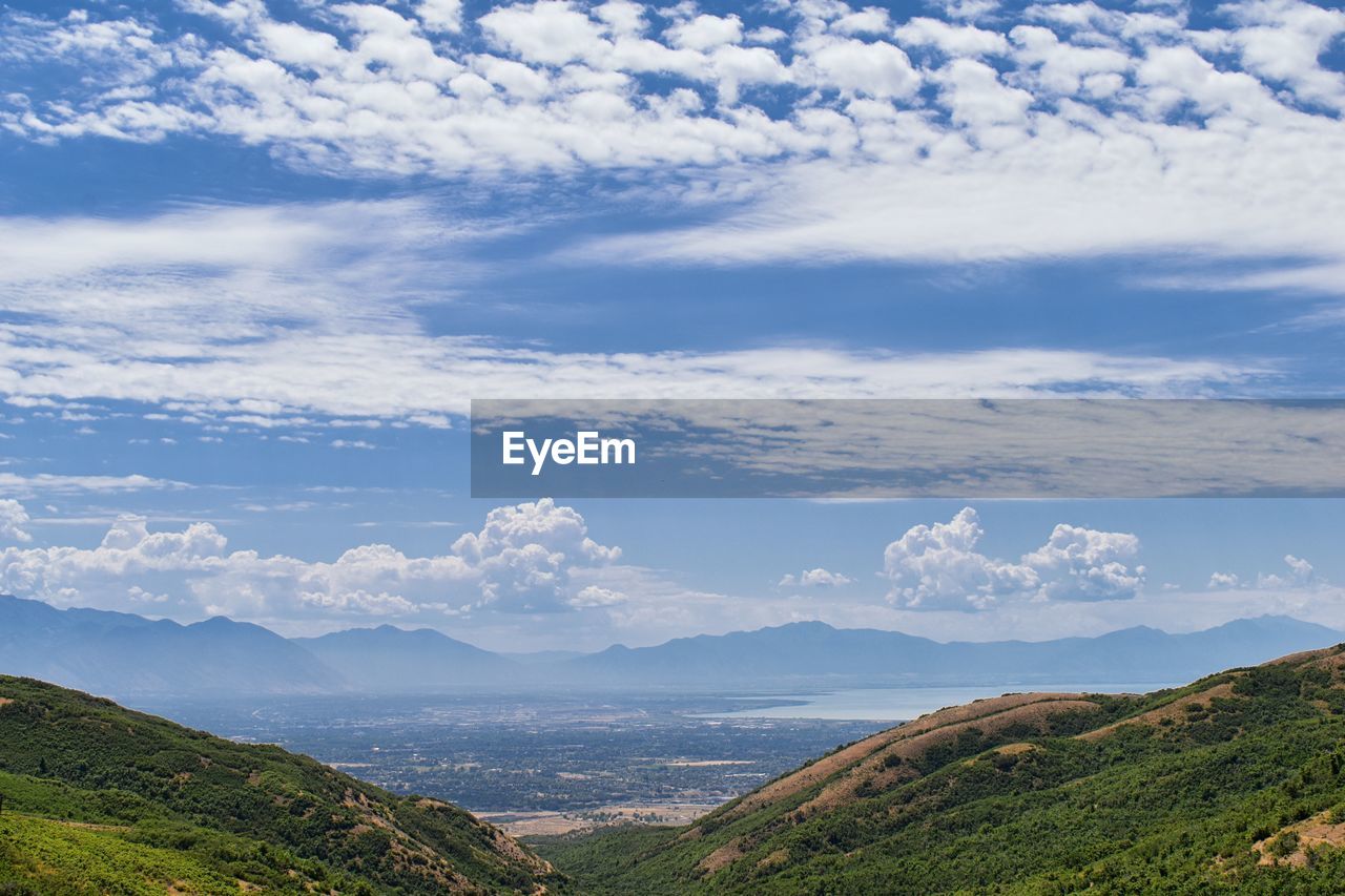 SCENIC VIEW OF SEA BY MOUNTAINS AGAINST SKY