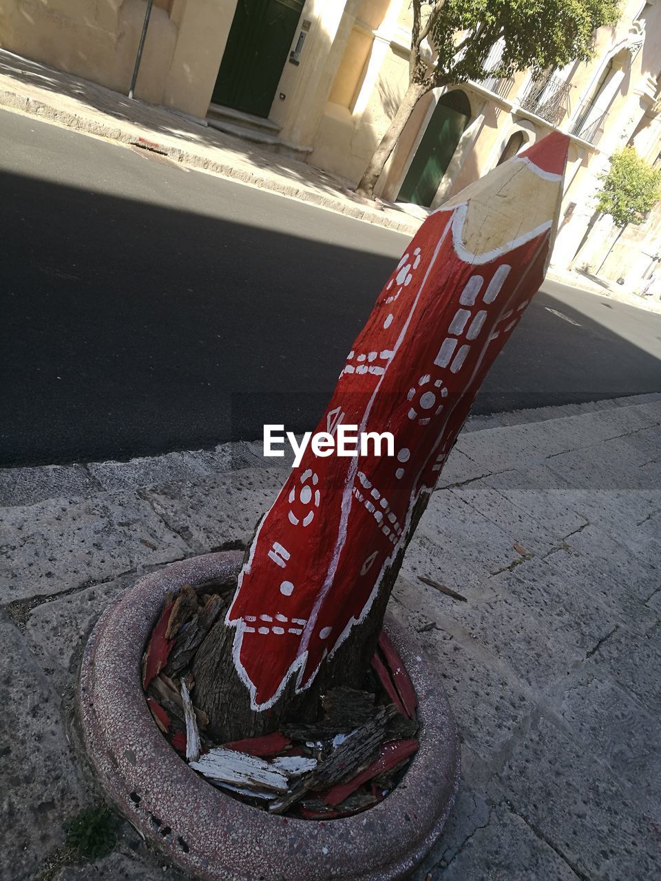 HIGH ANGLE VIEW OF RED CAR ON STREET