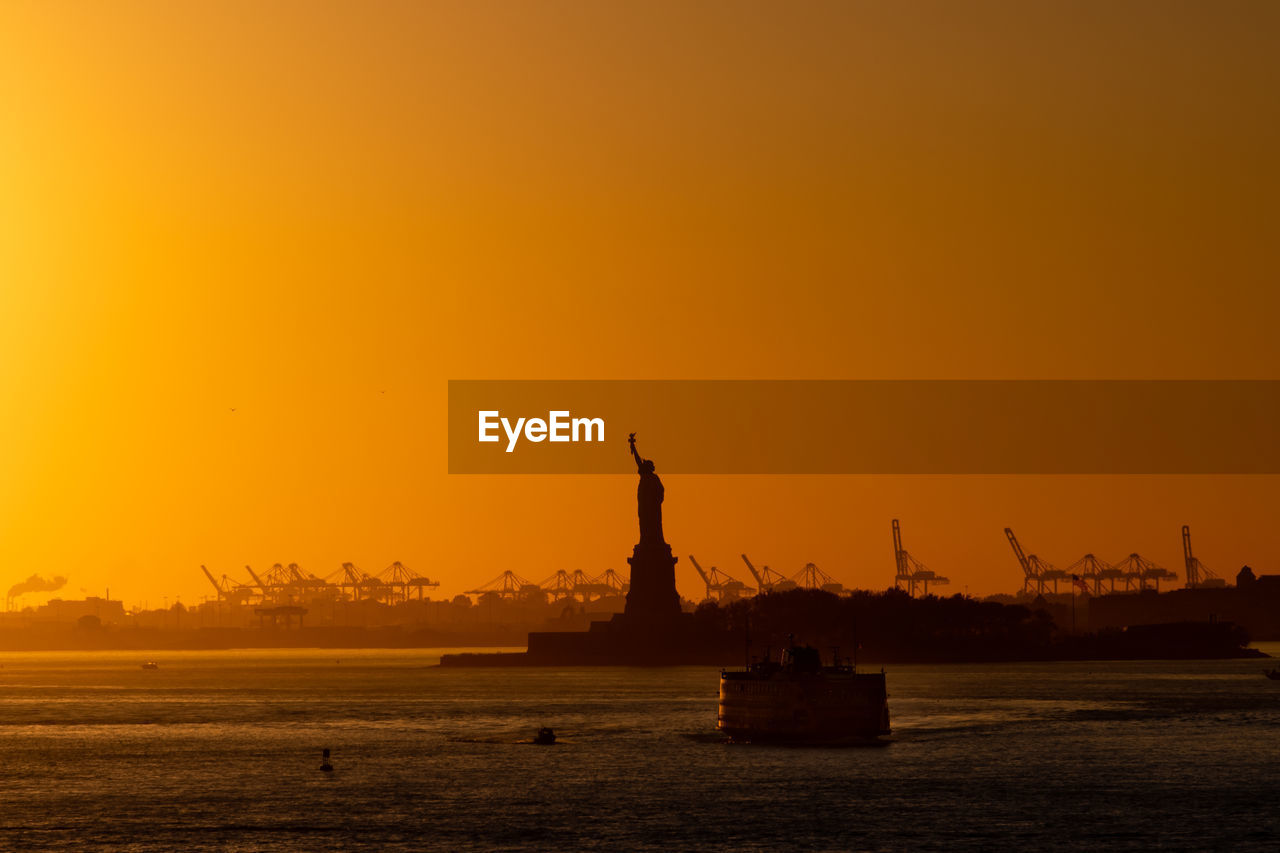 Silhouette of sculpture at sunset