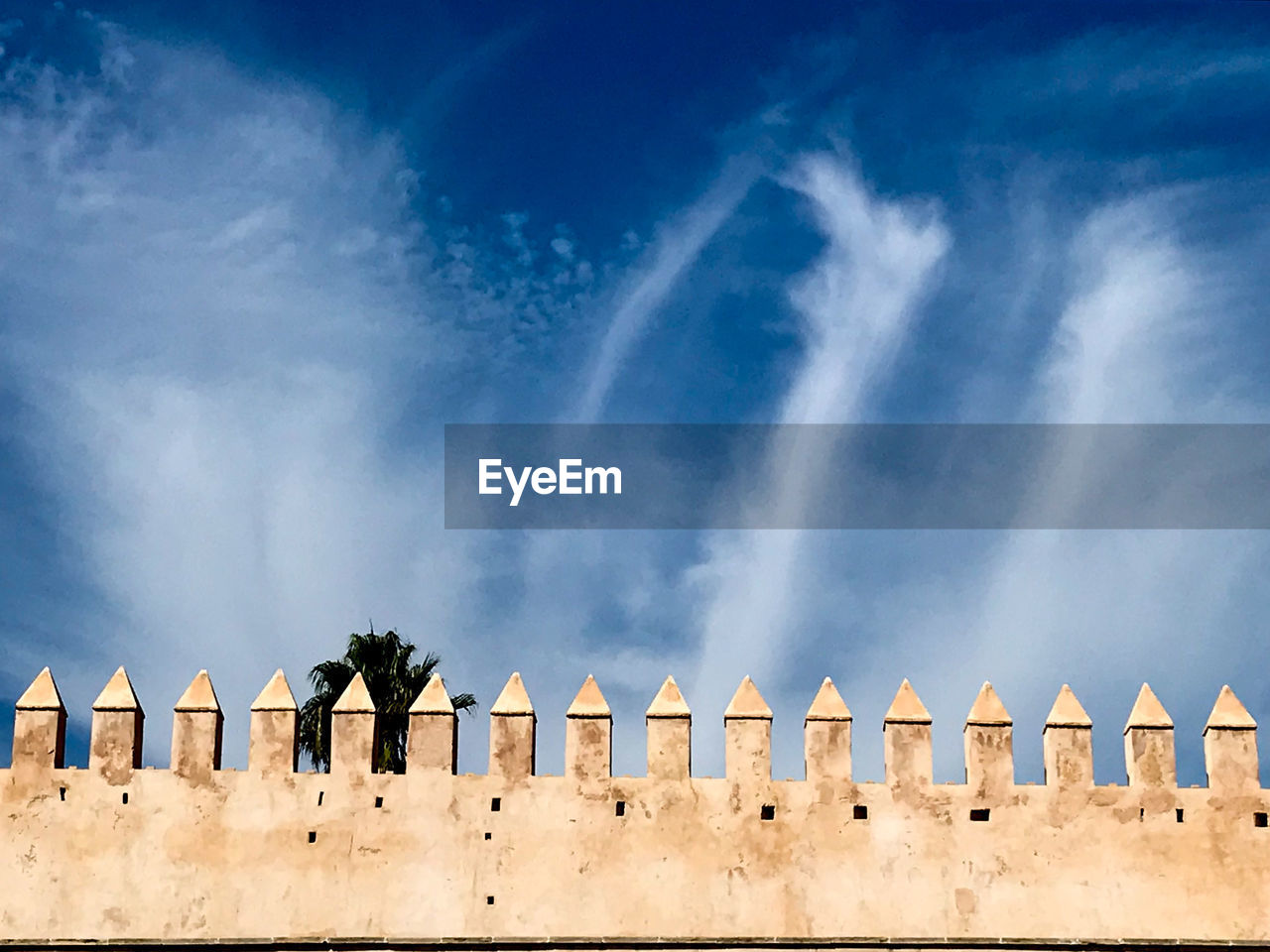 PANORAMIC VIEW OF BUILDING AGAINST CLOUDY SKY