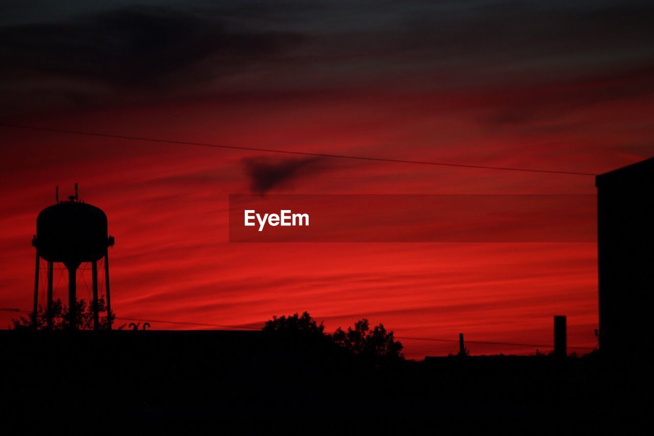 Low angle view of silhouette trees against sky during sunset