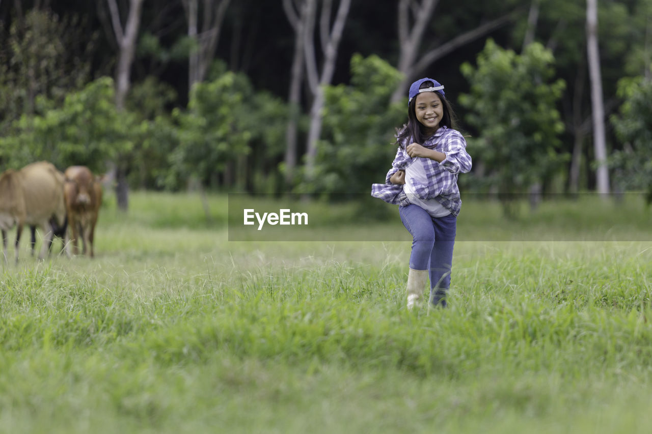 Cute girl playing on grass at park