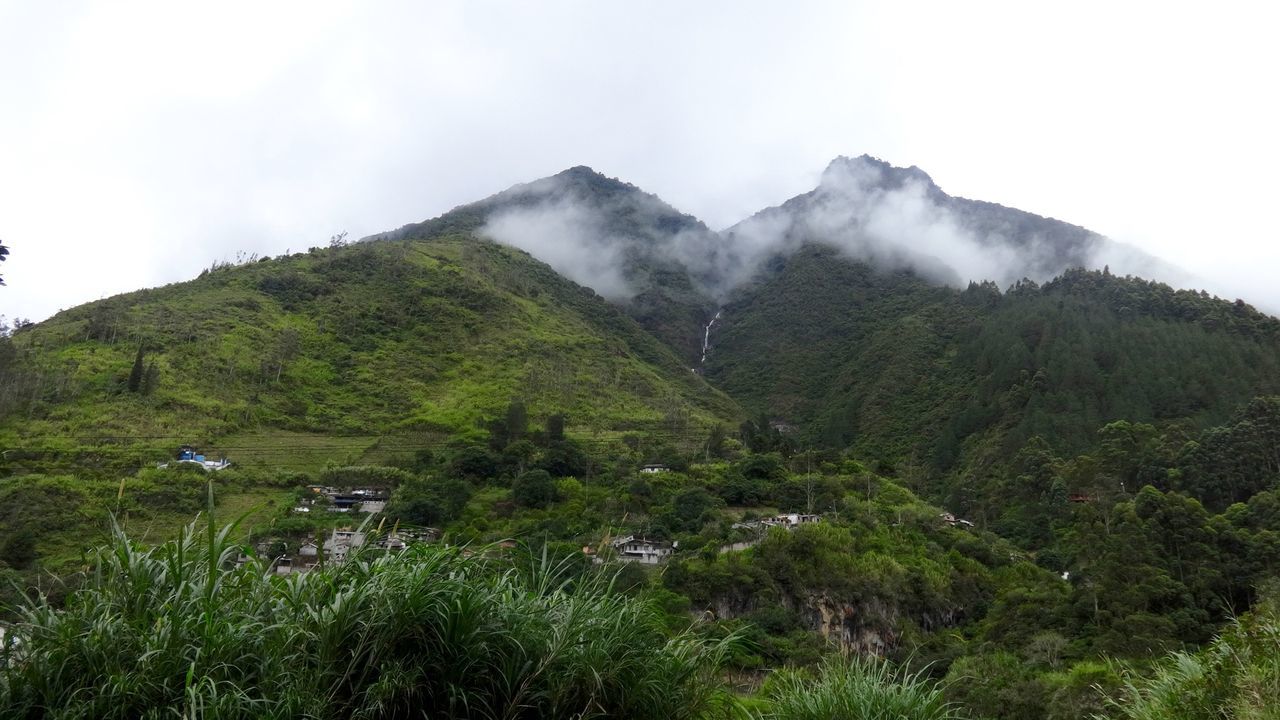 Scenic view of mountain against cloudy sky