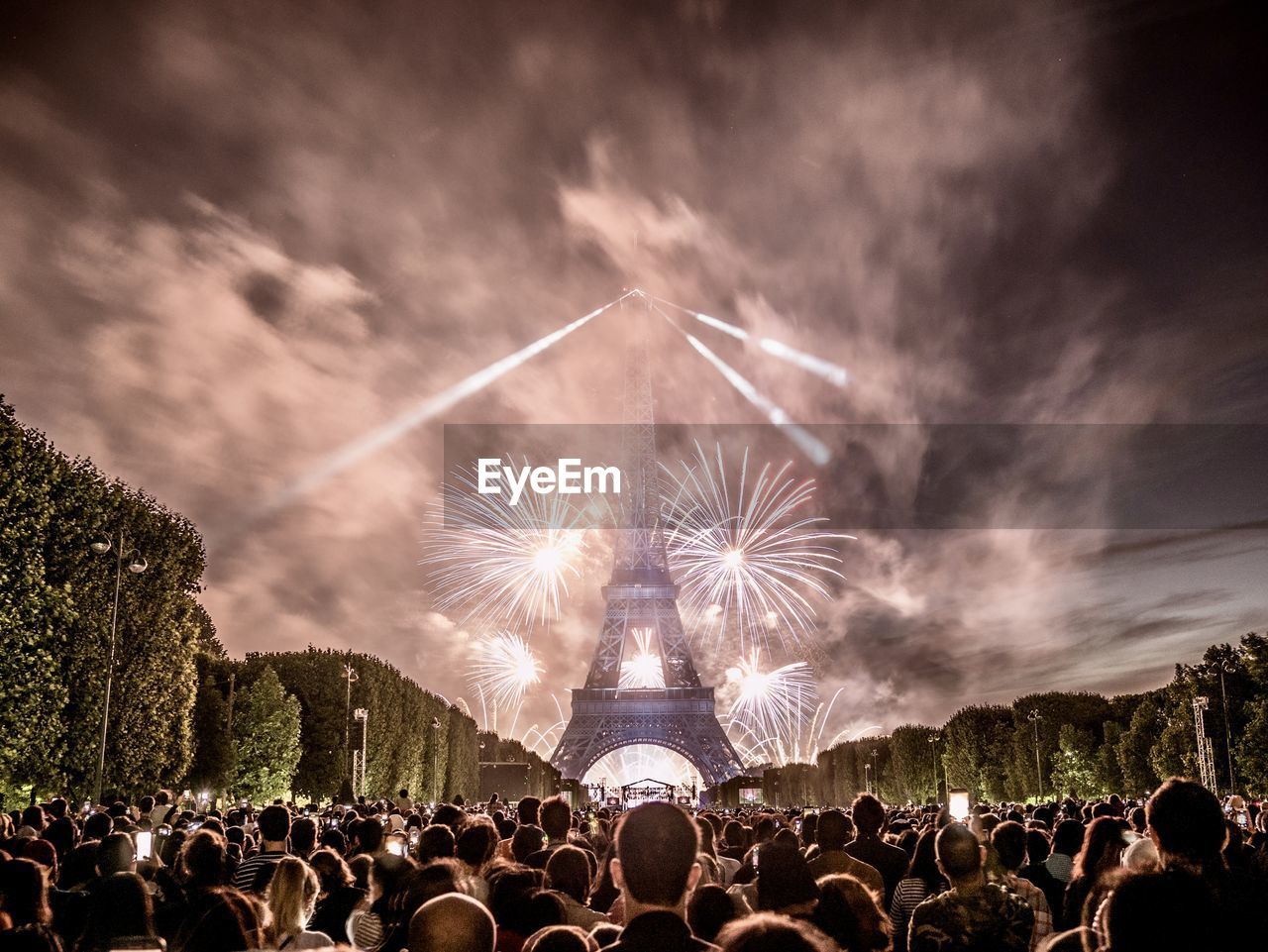 Low angle view of people at fireworks at eiffel tower in paris 