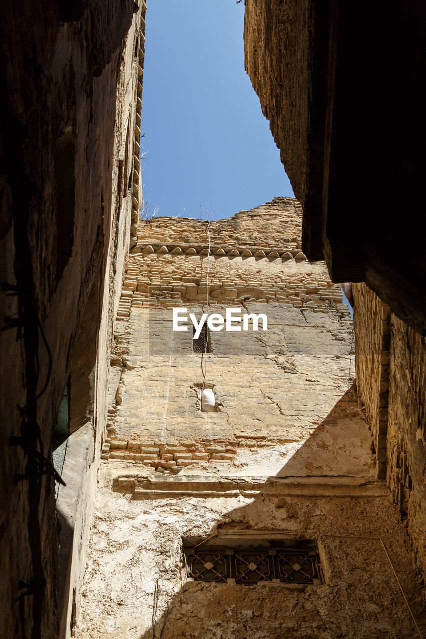 Low angle view of old building against clear sky