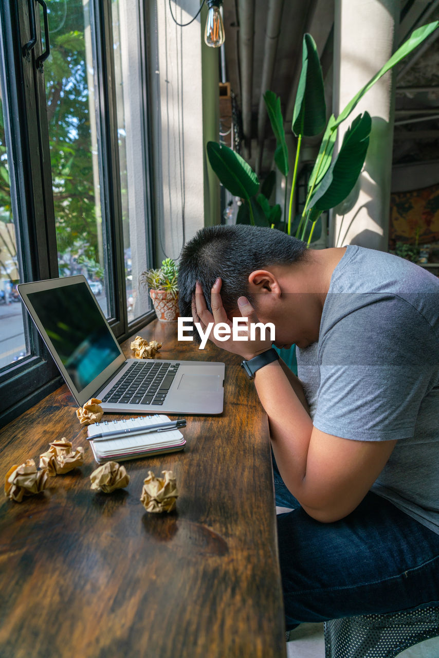 Frustrated man sitting at home