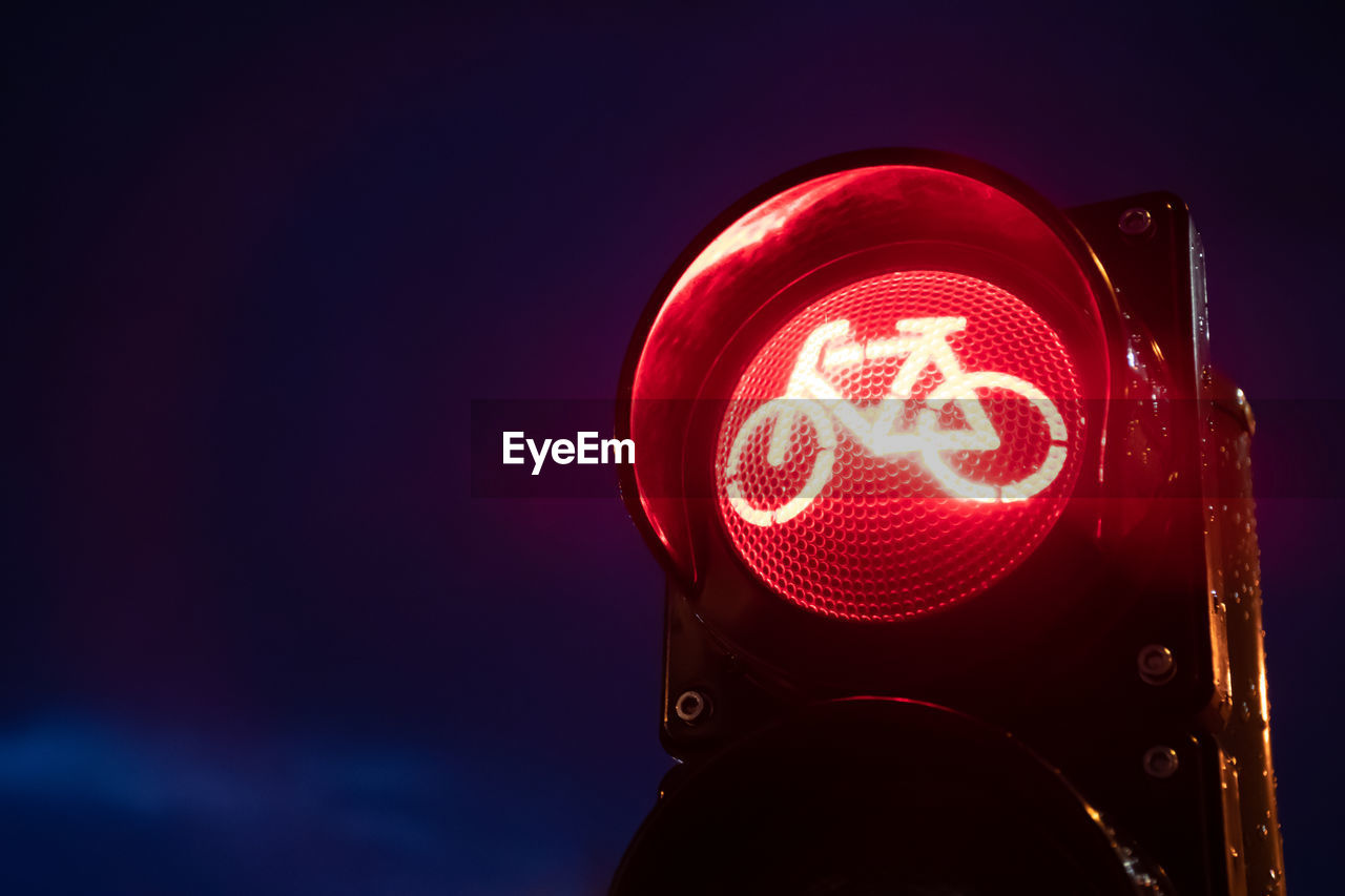 Close-up of road signal against sky