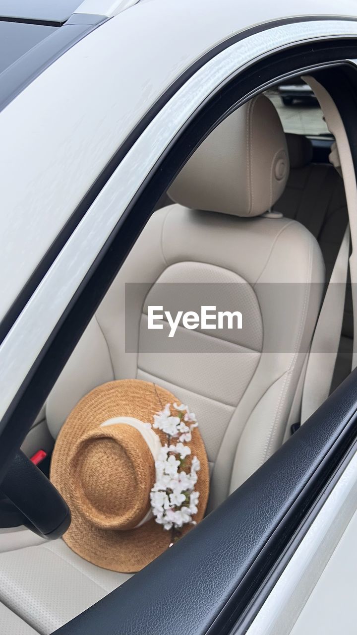 car, vehicle, transportation, land vehicle, mode of transportation, motor vehicle, automotive exterior, luxury vehicle, automobile, executive car, steering wheel, wheel, car seat, fashion accessory, vehicle interior, no people, travel, city car, sun hat, hat, food and drink, indoors, wealth, cowboy hat