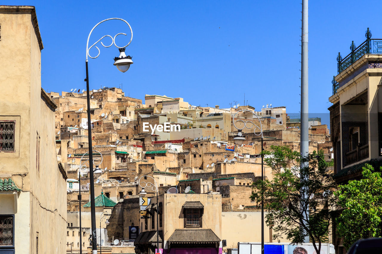 Low angle view of buildings against clear blue sky