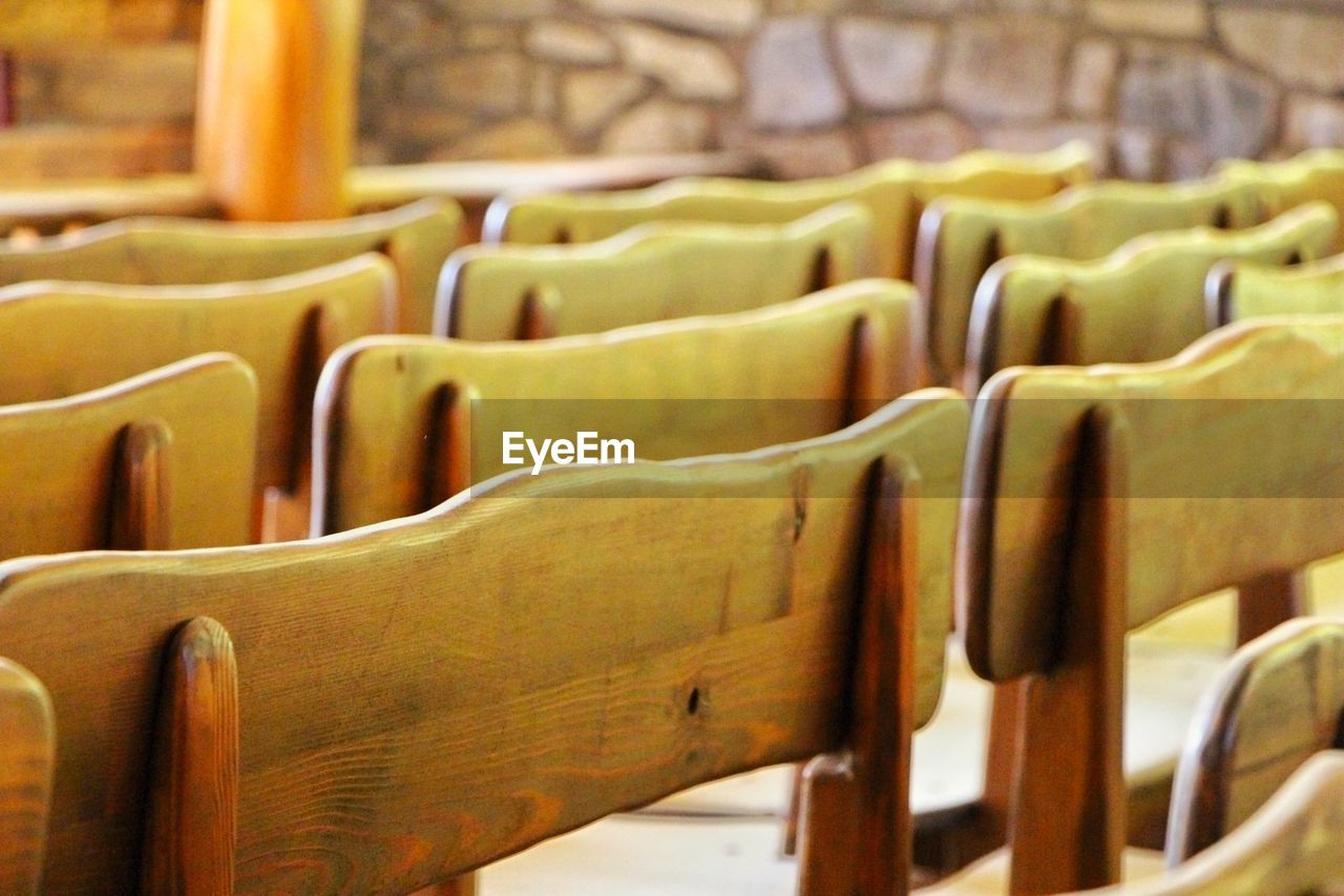 Close-up of wooden seats in row