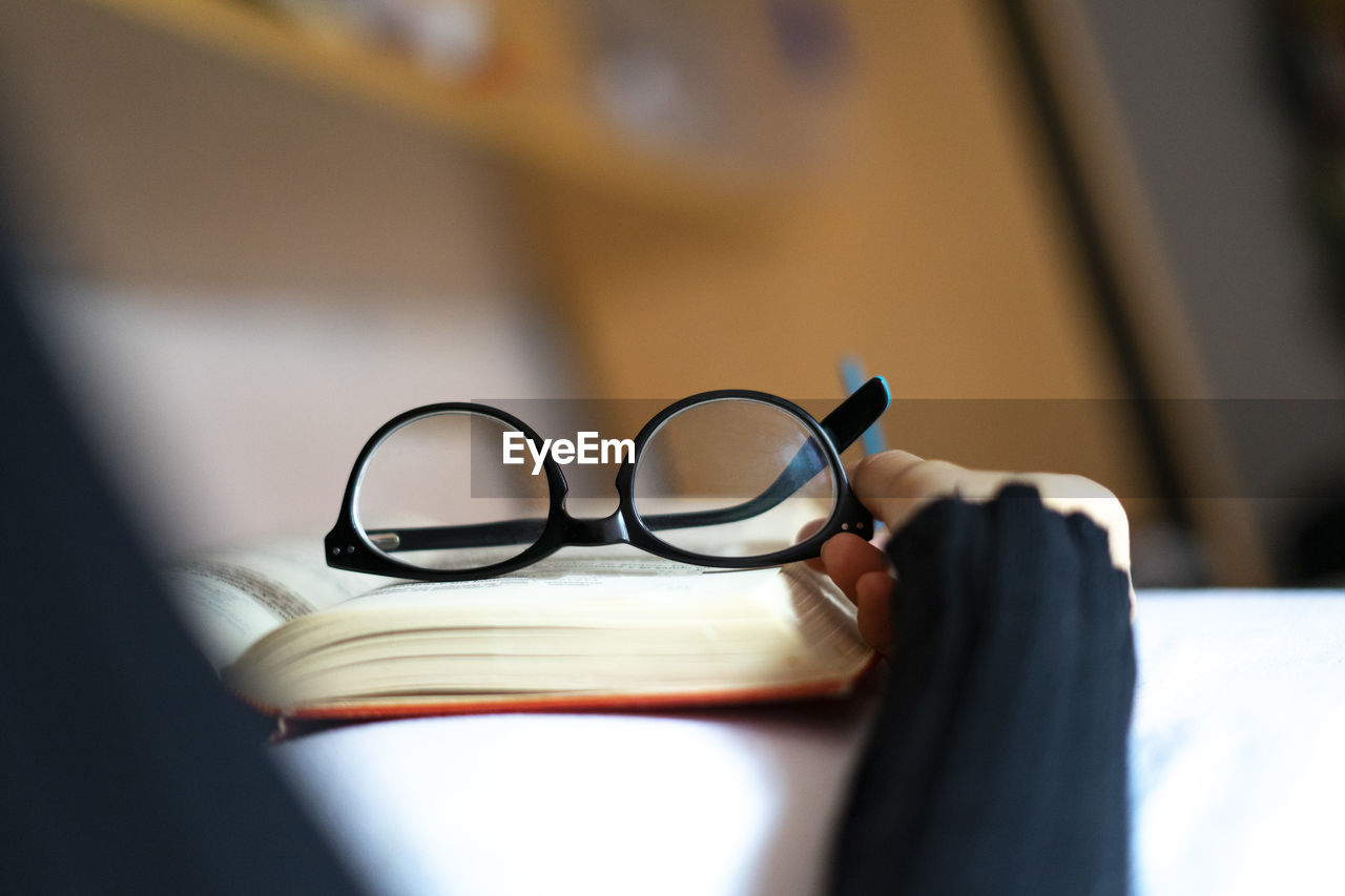 Reading glasses on top of a book.