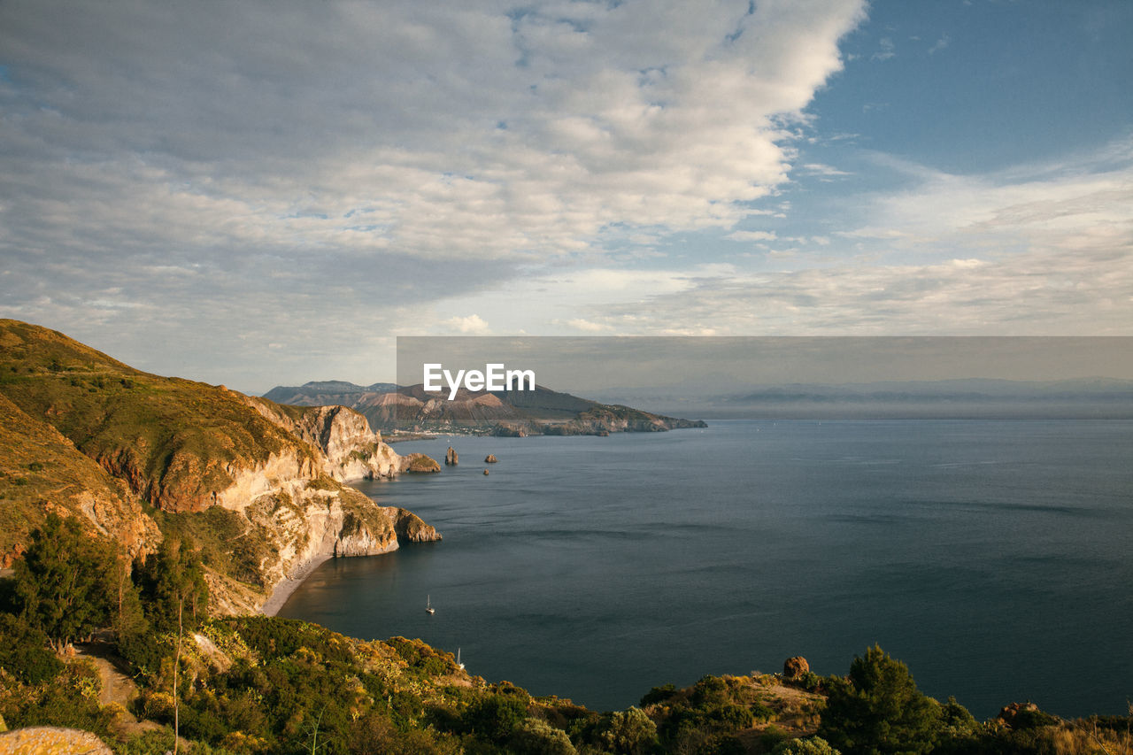 The view on the cliffs, coastline with island on the background, tranquil nature scene.