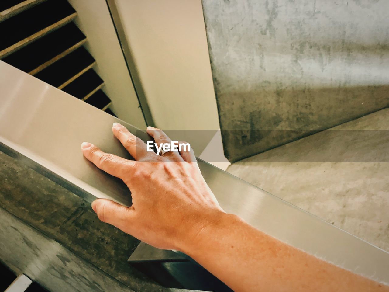 Cropped hand of woman on railing