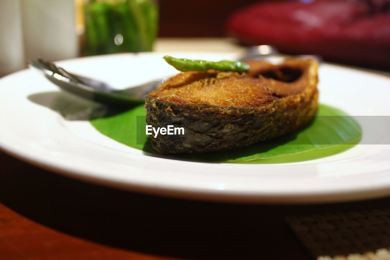 Close-up of fish in plate on table