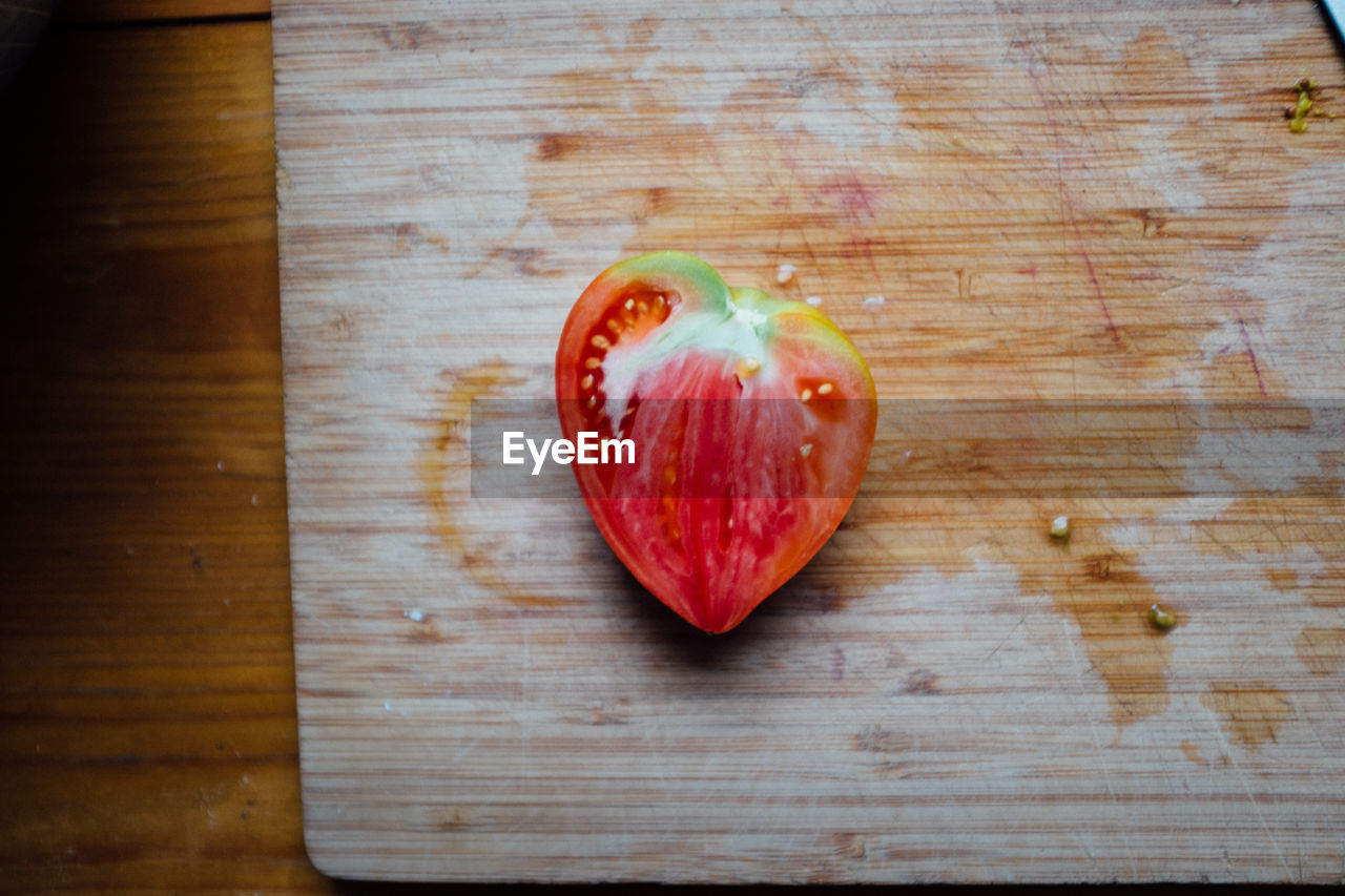 High angle view of heart shape tomato on cutting board