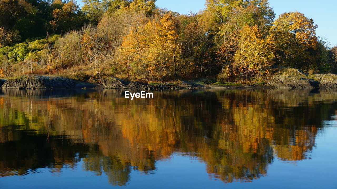 Scenic view of calm lake against cloudy sky