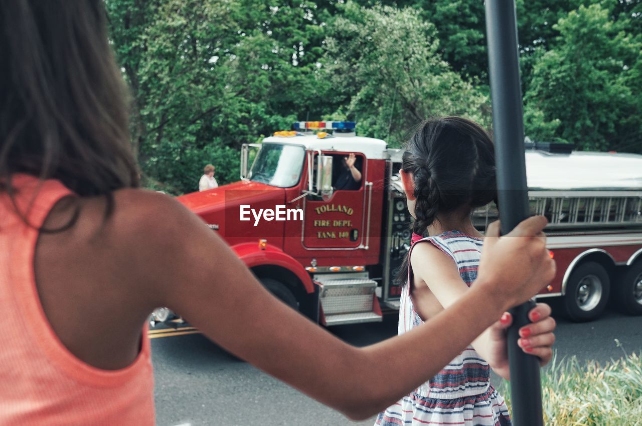 WOMAN PHOTOGRAPHING THROUGH TRAIN