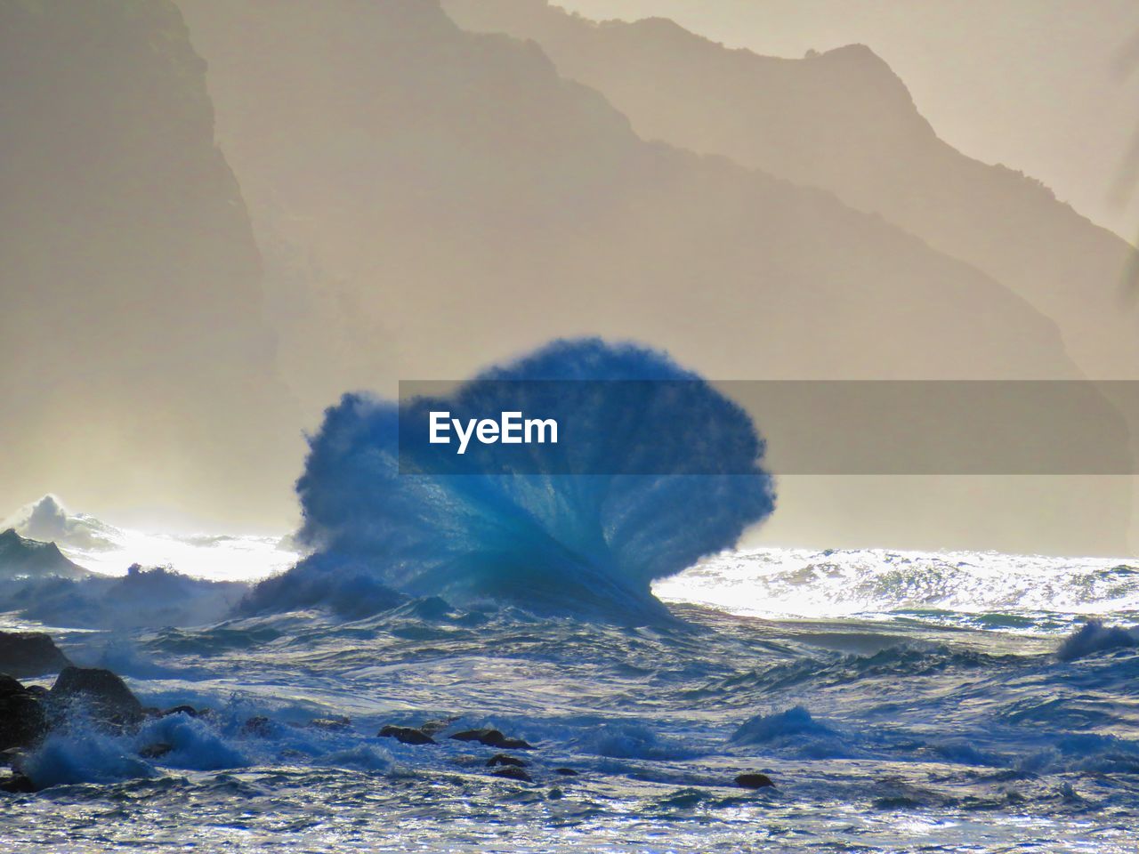 Scenic view of sea and mountains against sky