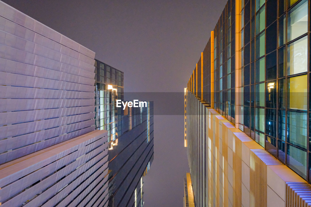 ILLUMINATED BUILDING AGAINST SKY AT NIGHT