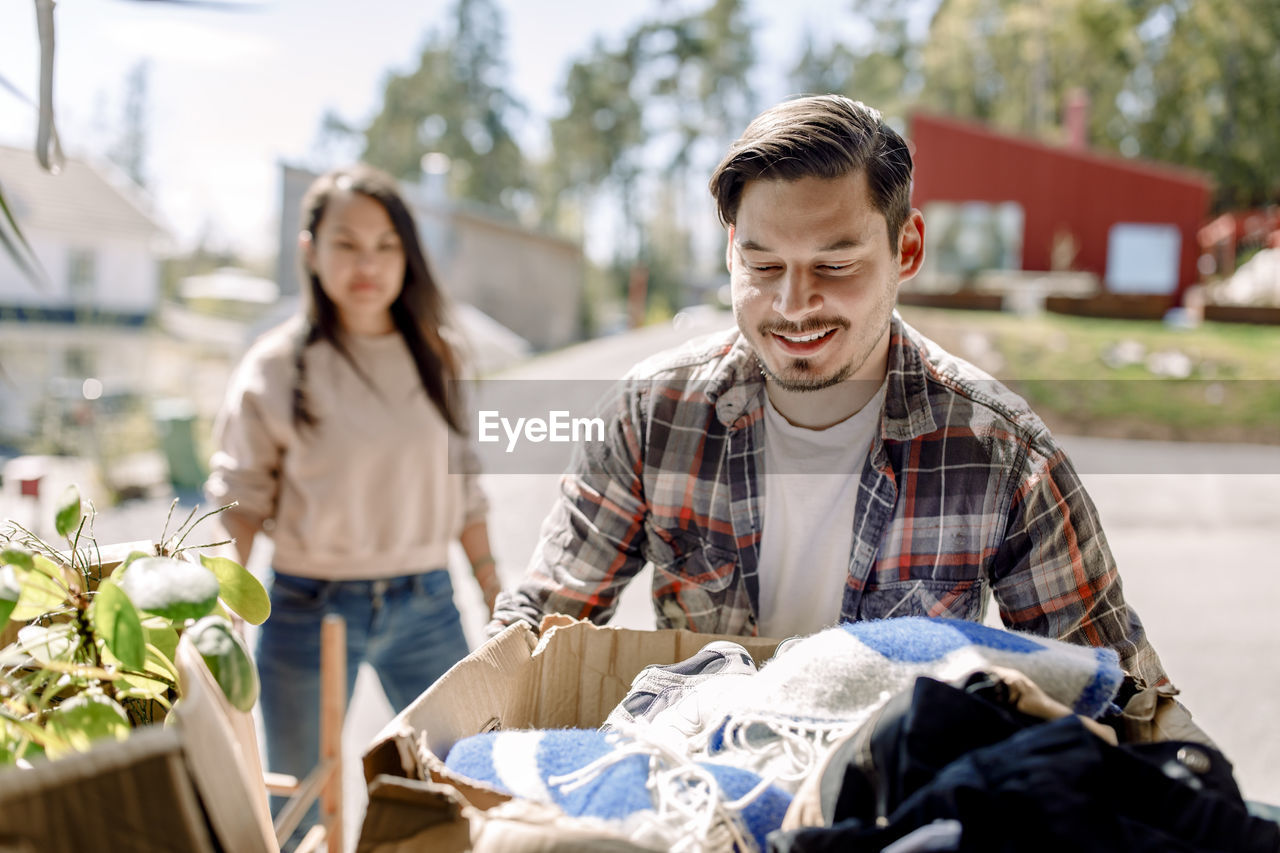 Man carrying cardboard box while moving in new house