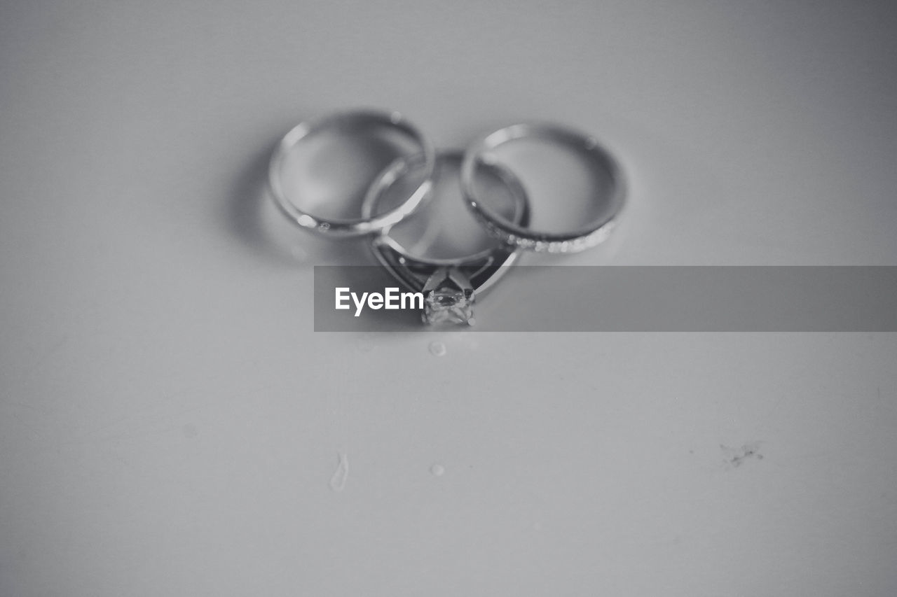 High angle view of wedding rings on white background