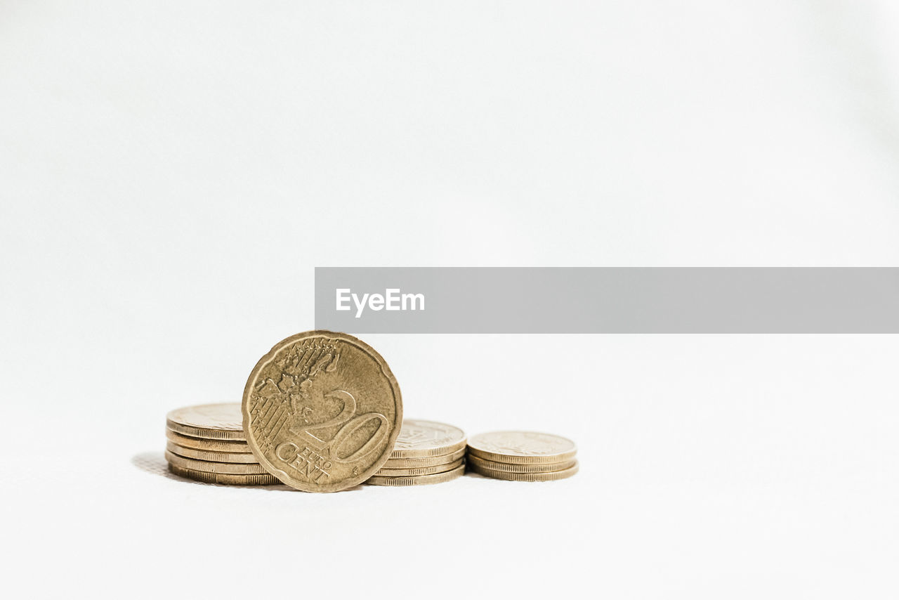 Close-up of coins against white background