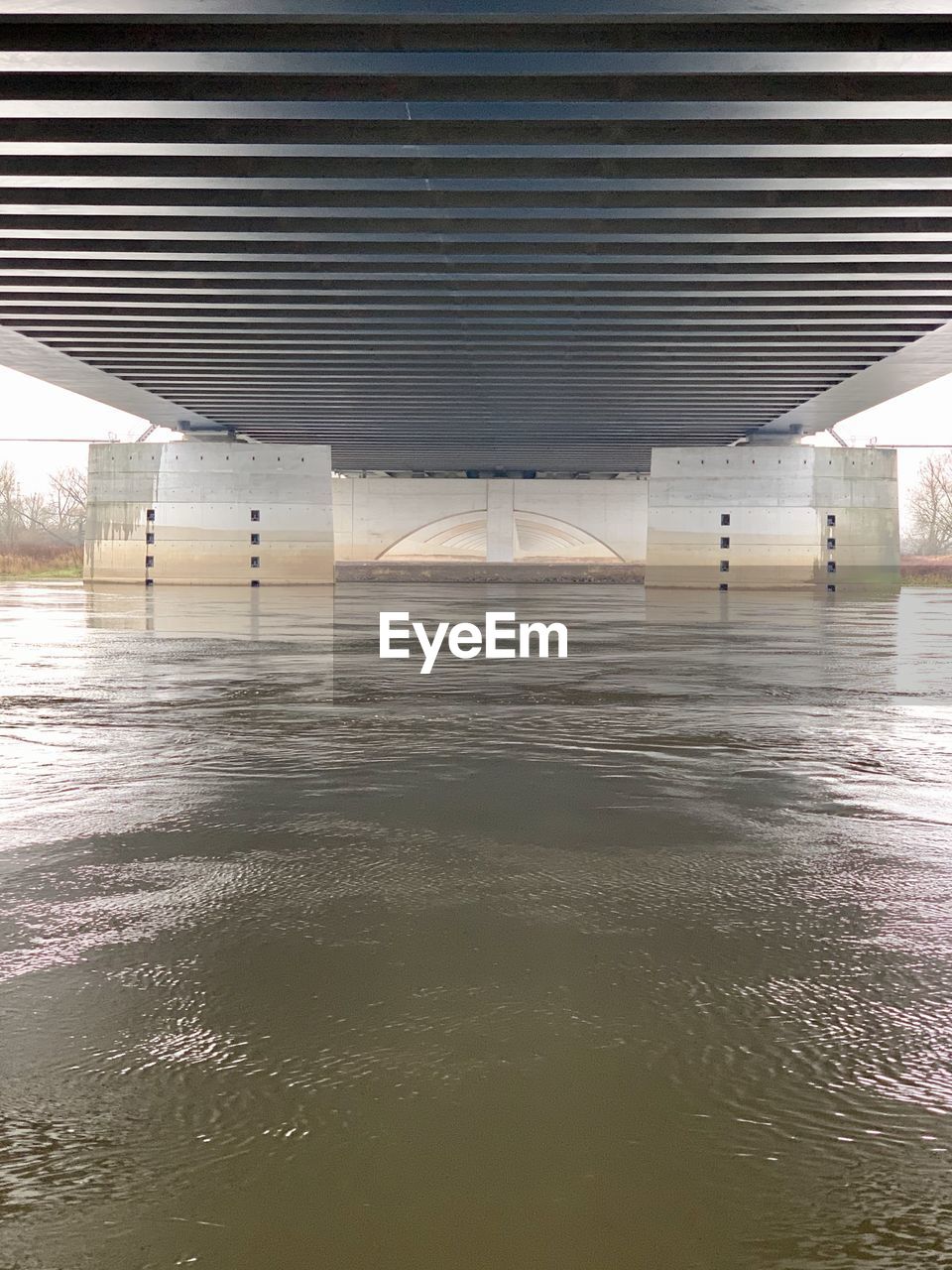 REFLECTION OF BRIDGE ON WATER IN ILLUMINATED MIRROR