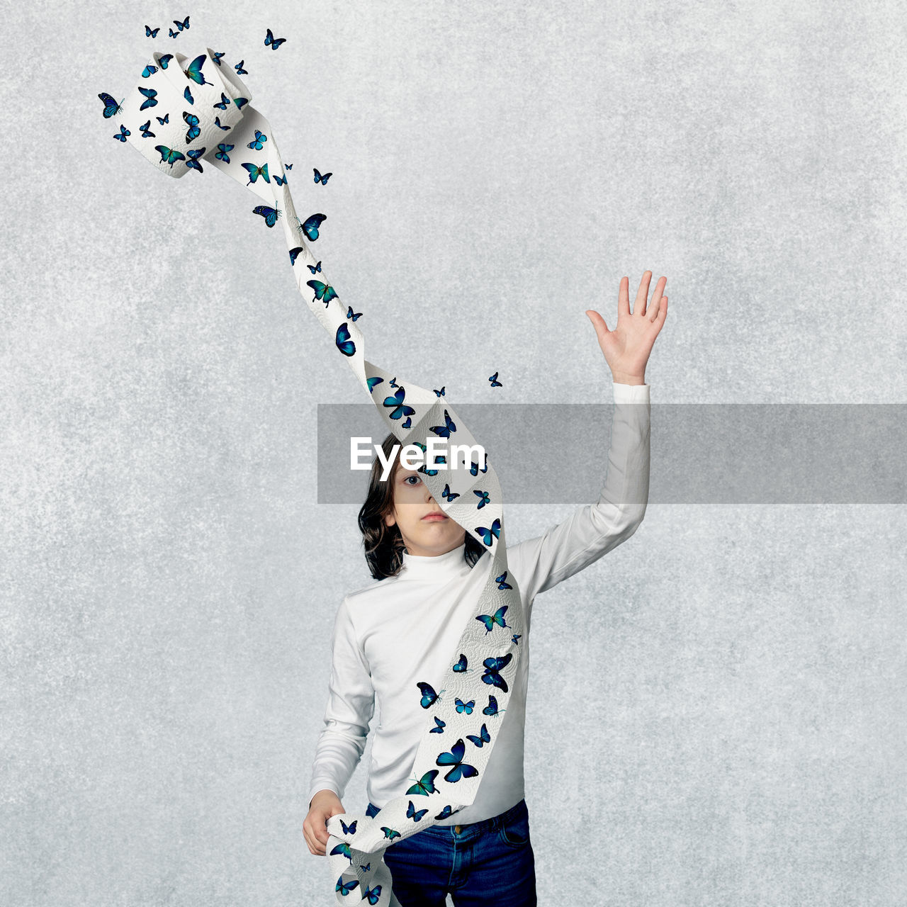 Portrait of a kid throwing toilet paper with butterflies