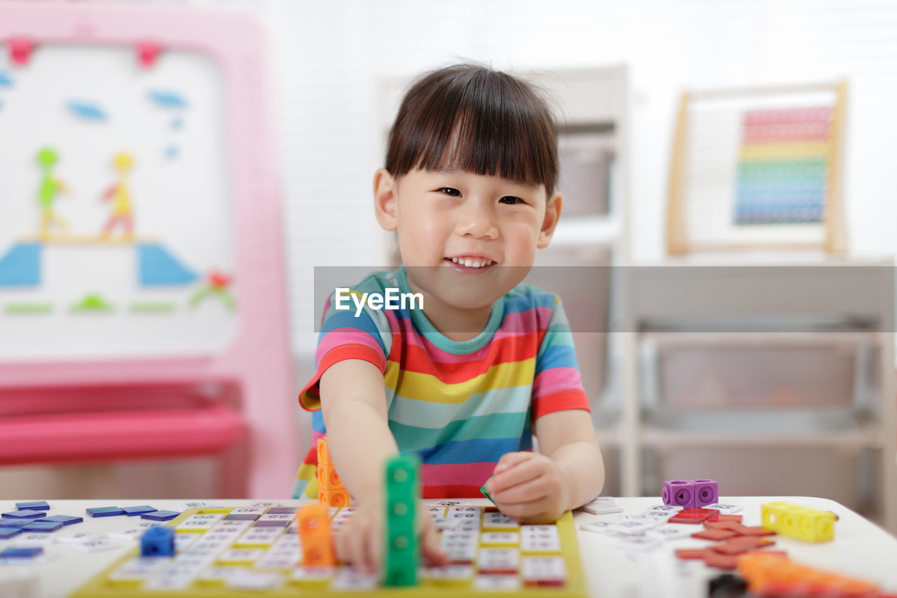 Young girl play number blocks for home schooling