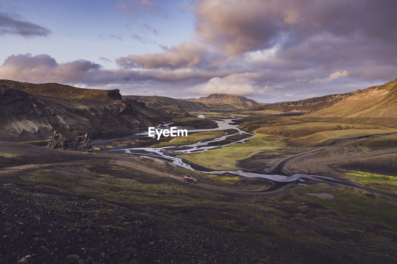 View of 4x4 about to cross river in wild valley in highlands iceland