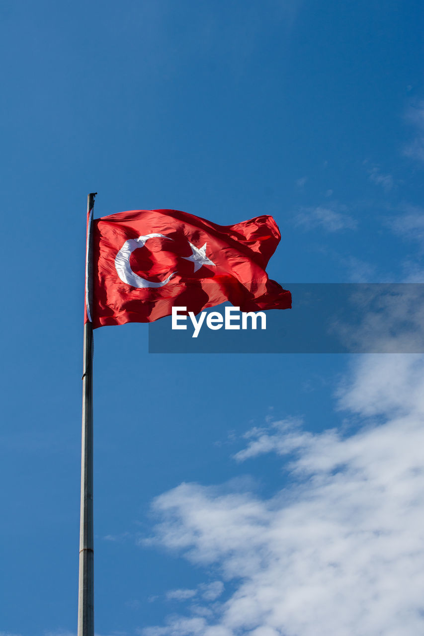 low angle view of flag against clear blue sky