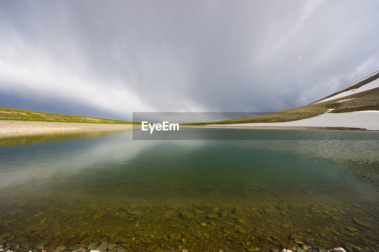 Alpine mountain lake landscape and view, snow and clouds in javakheti, georgia