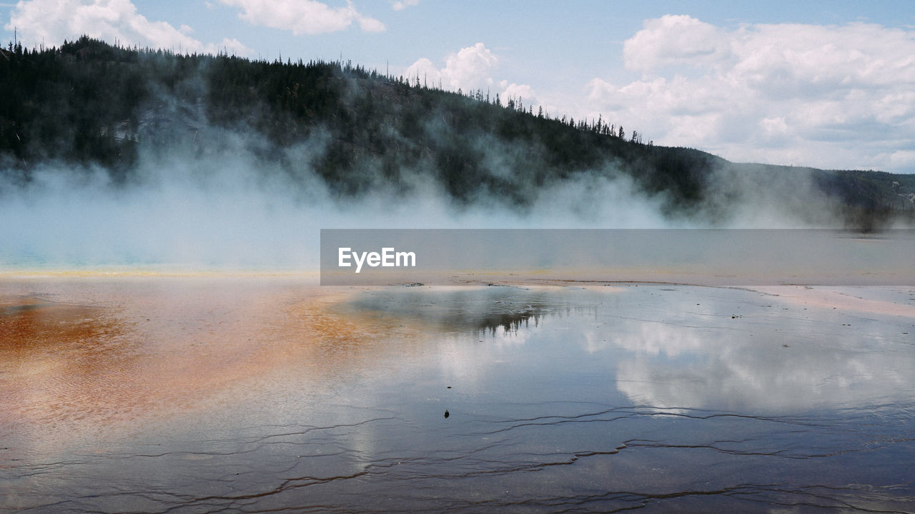 Scenic view of hot spring against mountain
