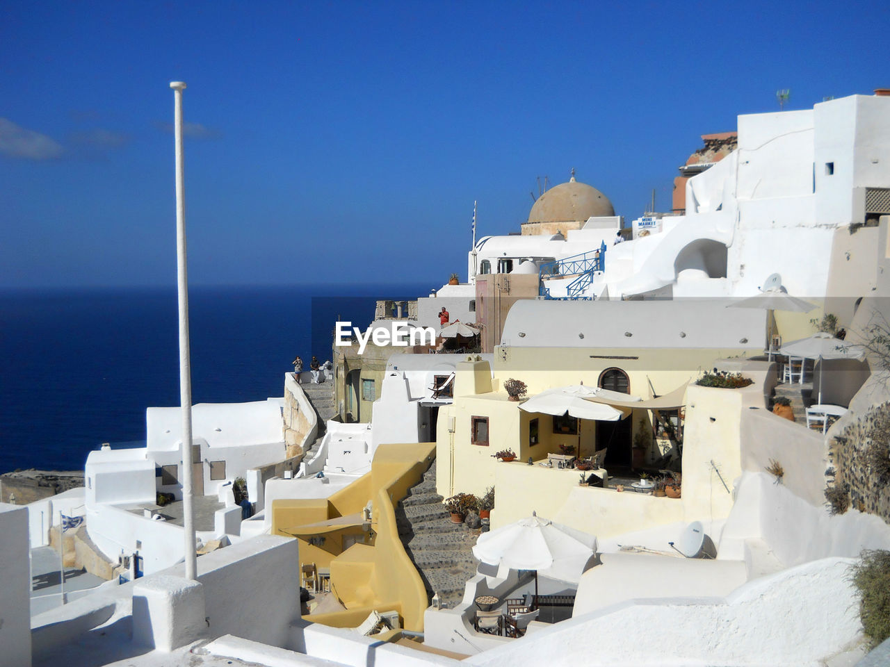 RESIDENTIAL BUILDINGS BY SEA AGAINST CLEAR BLUE SKY