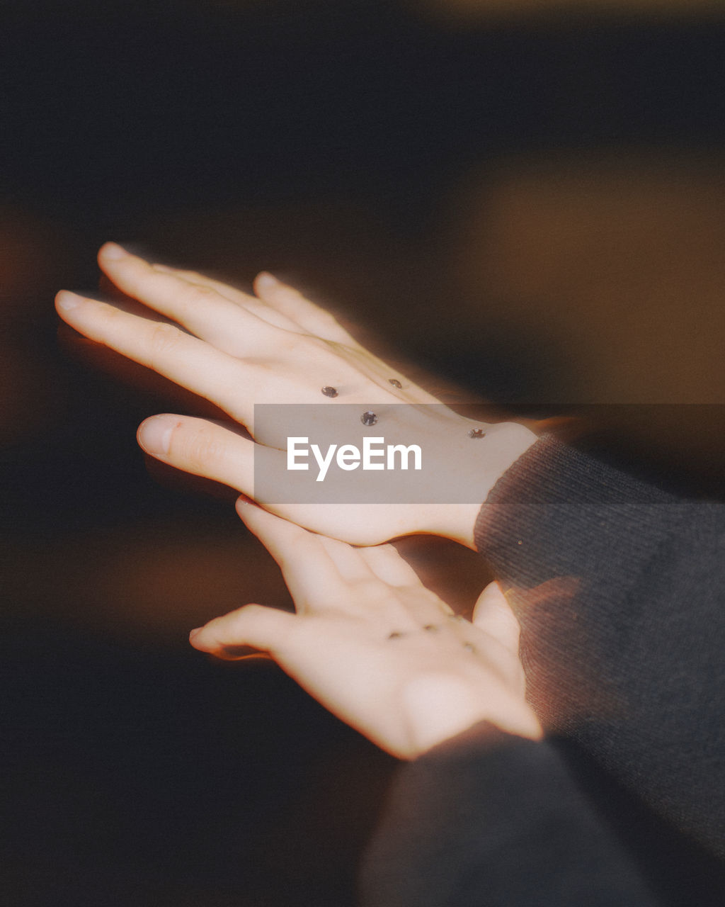 Close-up of woman hands with metallic buttons