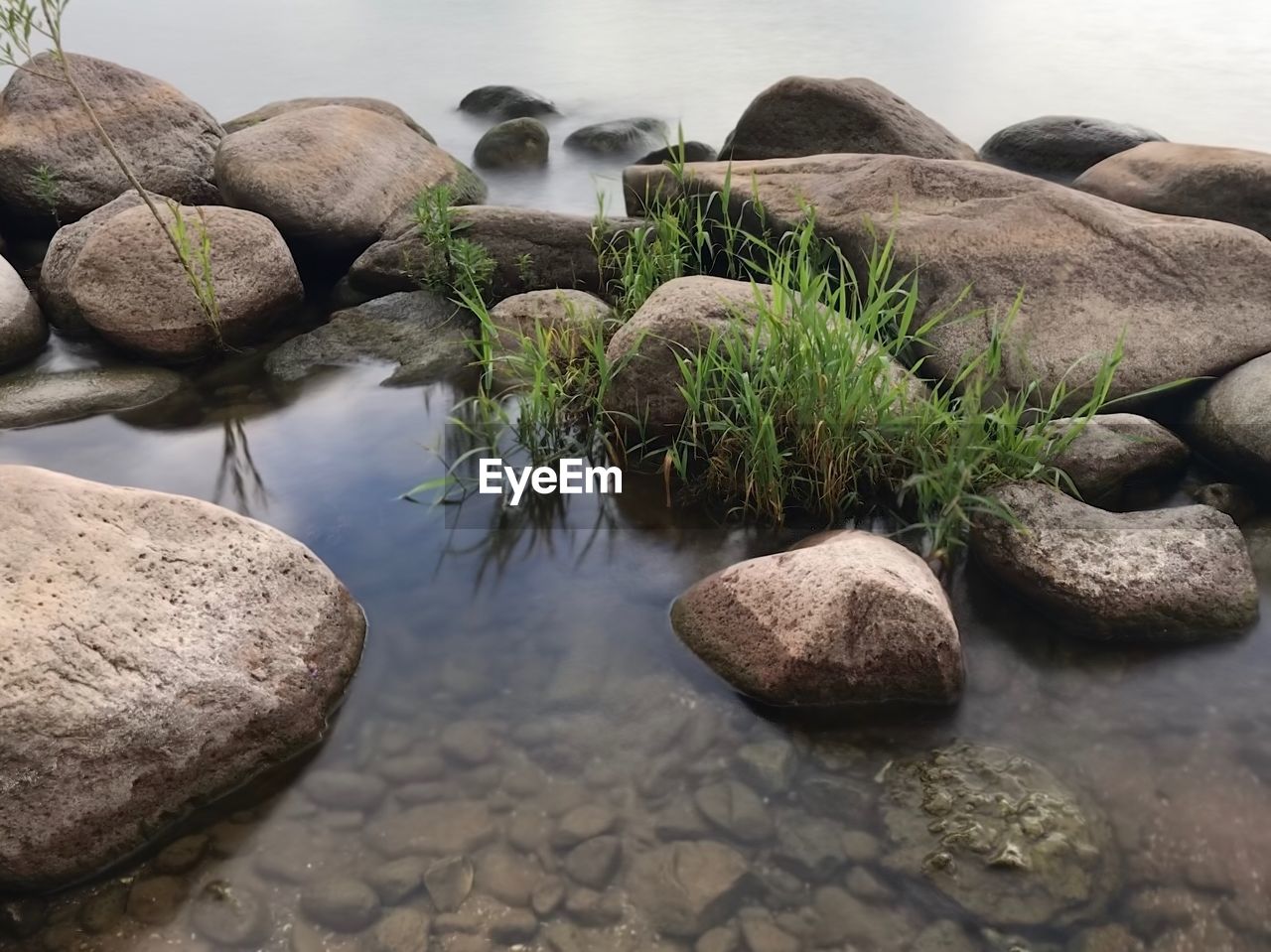 STONES ON ROCK BY LAKE