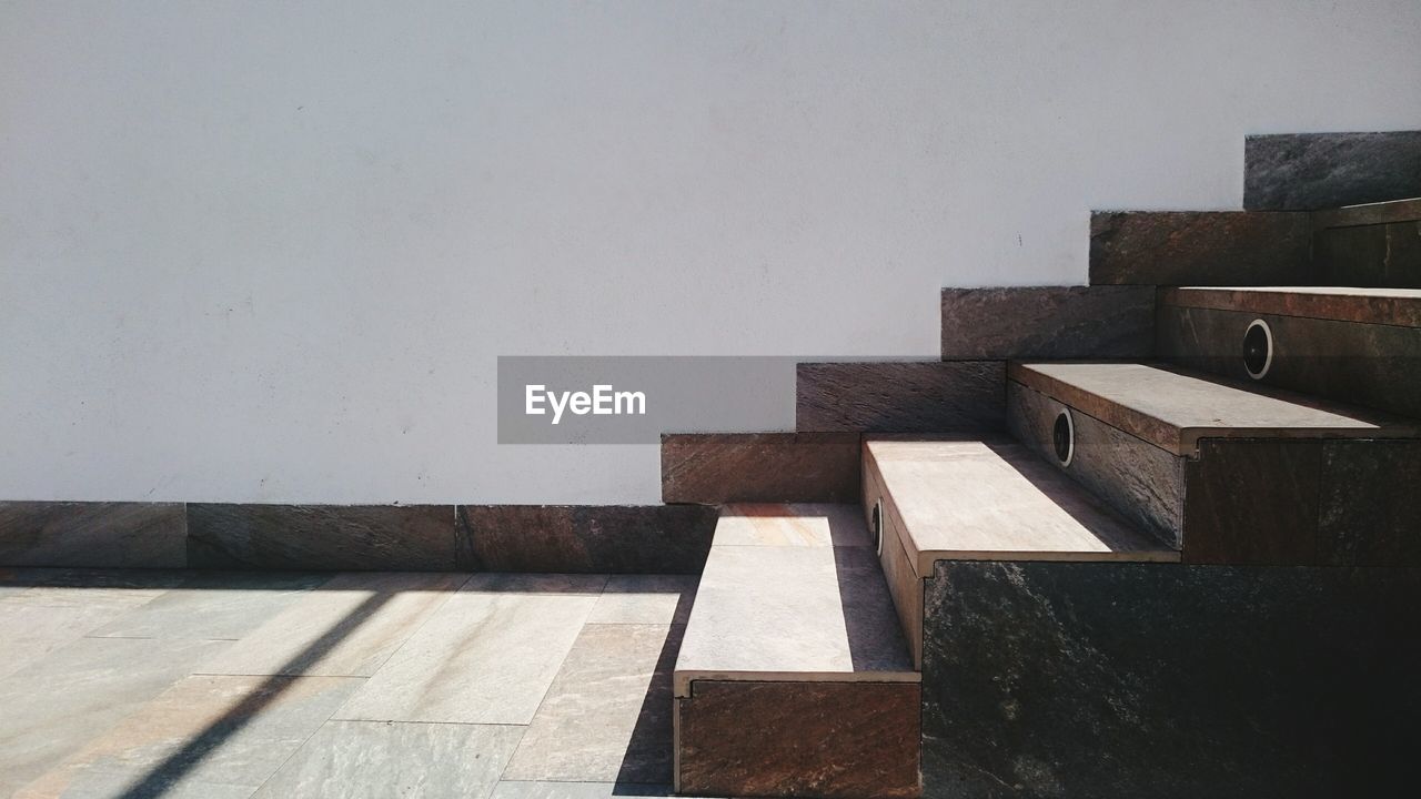 Wooden steps by wall