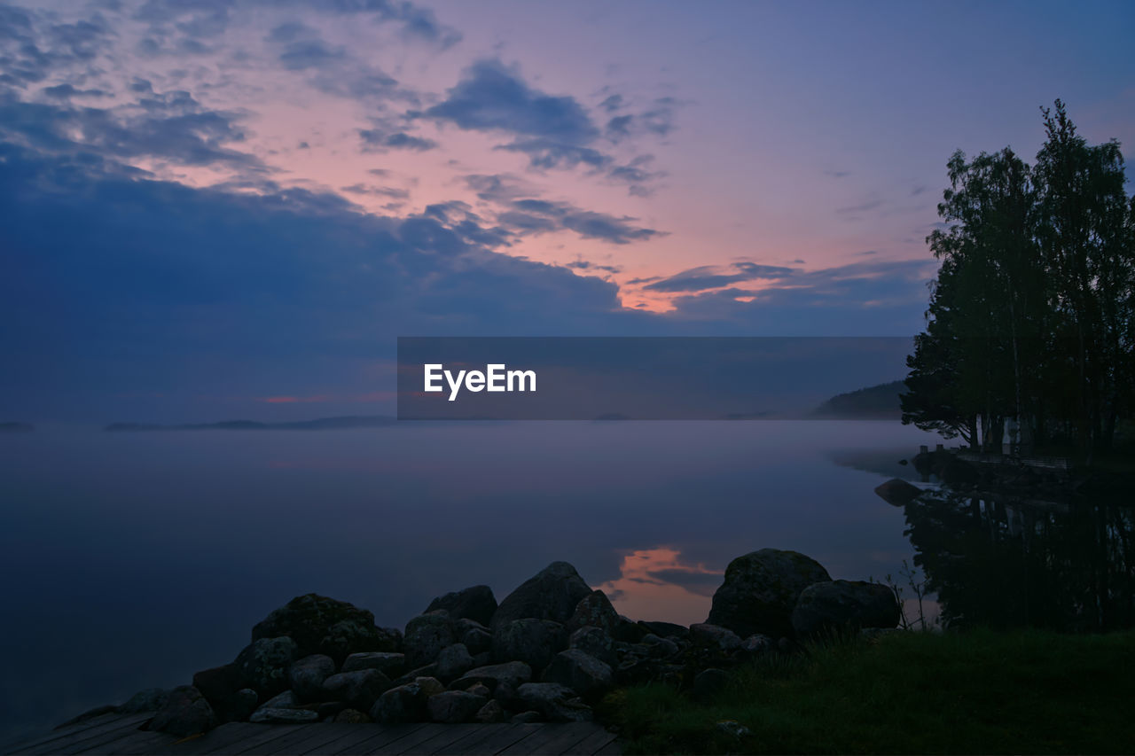 Scenic view of rocks against sky during sunset